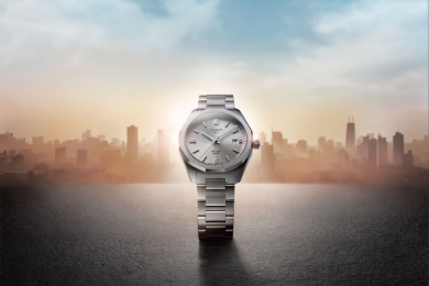 Image of a man taking a photo with a digital camera while wearing a Tissot Watch.